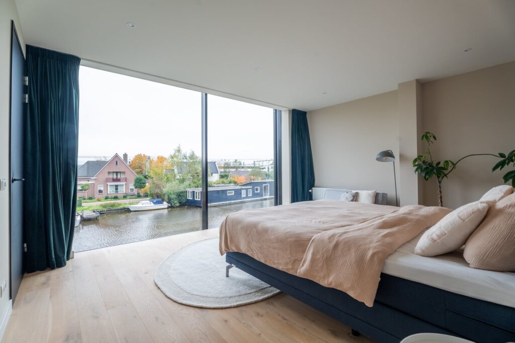Moderne woning met glazen gevel aan het water slaapkamer